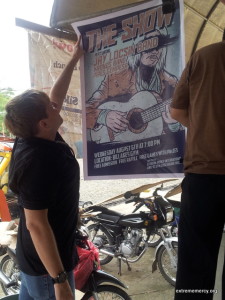 Hanging a poster right in front of the biggest store in Trento.