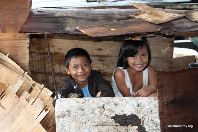 Children playing in the typhoon debris.